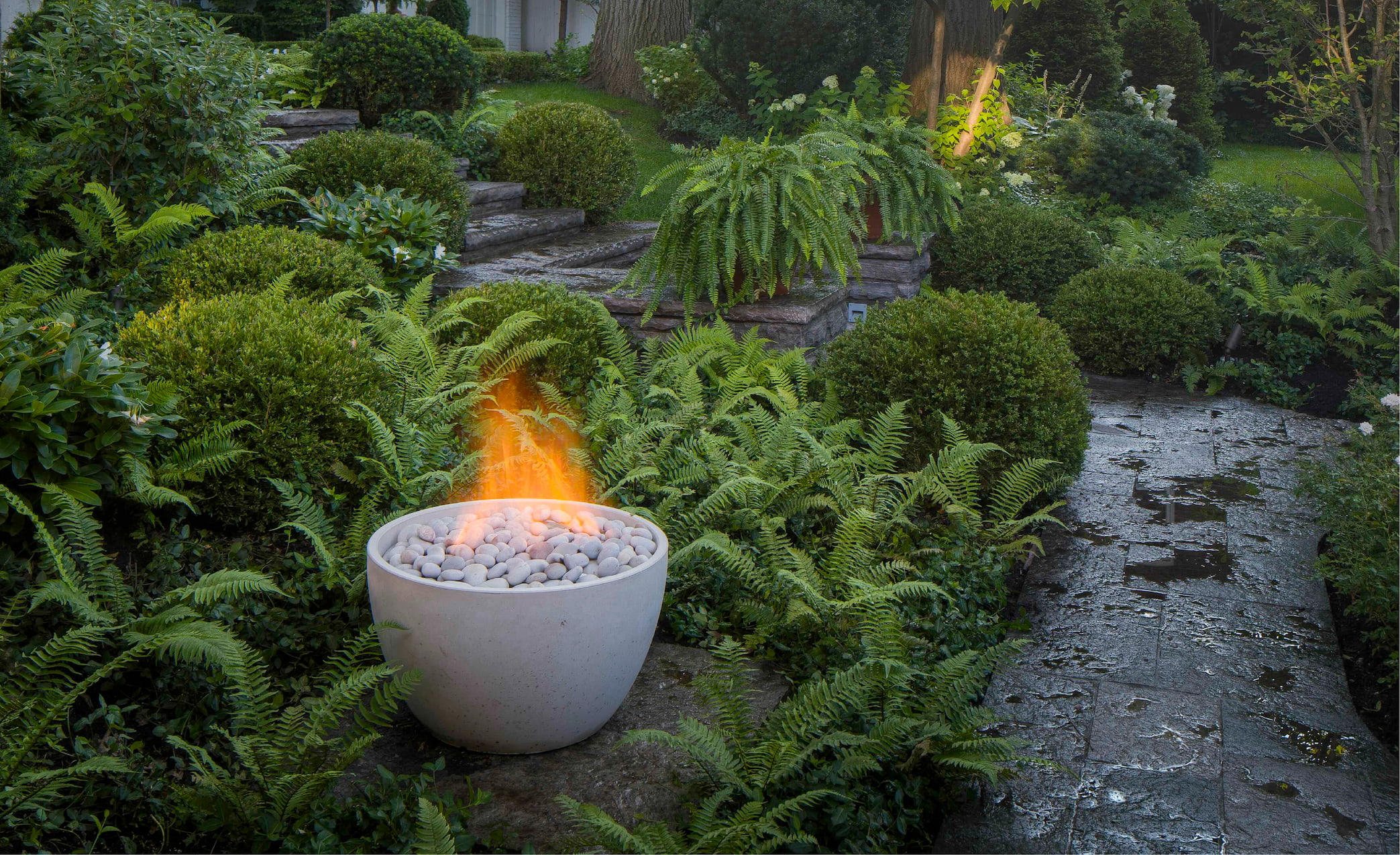 Soba fire bowl placed in a backyard garden | Modern Fire Bowls by Paloform