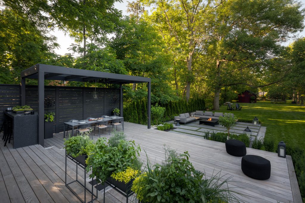 Contemporary yard with custom pergola, dining table, and a fold fire pit