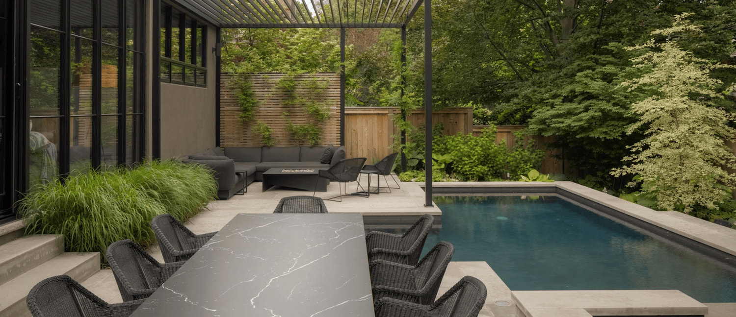 Poolside retreat featuring a square fire pit